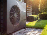 Air heat pump near pool house outdoors.